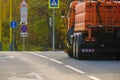 Rear view of an orange multifunctional heavy duty truck for cleaning an asphalt street Royalty Free Stock Photo