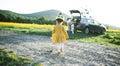 Rear view os small girl with family going on cycling trip in countryside. Royalty Free Stock Photo