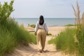 Rear view of an overweight woman walking alone on the beach