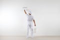 Rear view of painter man painting the wall, with paint roller an Royalty Free Stock Photo