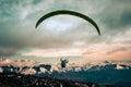 Rear view of paragliding over mountains of Bariloche in Argentina, with snowed peaks in the background. Concept of freedom, Royalty Free Stock Photo