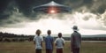 Rear view of paranoid family wearing tinfoil hats and looking at ufo in the sky, concept of Alien invasion anxiety