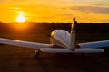 Rear view of a parked small plane on a sunset background. A silhouette of a grounded private jet at dusk. Piper Cherokee Royalty Free Stock Photo