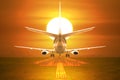 Rear view passenger aircraft takeoff on runway in sunset