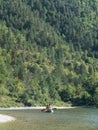 Rear view of People kayaking a kayak in spring river water