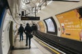 Rear view of people walking on the platform of Embankment tube station, London, UK Royalty Free Stock Photo