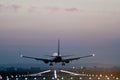 Rear view of a plane taking off from a runway at an airport