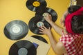 Rear view portrait pin up girl with old vinil records. Selective