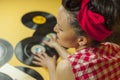 Rear view portrait pin up girl with old vinil records. Selective