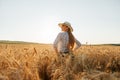 portrait of a woman farmer with hat standing in golden wheat field Royalty Free Stock Photo