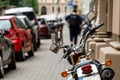 Rear view of powerful motorcycle parked on a sidewalk, blurred street in a background Royalty Free Stock Photo