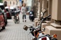 Rear view of powerful motorcycle parked on a sidewalk, blurred street in a background Royalty Free Stock Photo