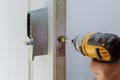 Rear view of repairman installing electronic key of the door lock