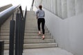 Rear view of runner athlete running on stairs. Woman fitness is jogging oudoors Royalty Free Stock Photo