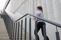 Rear view of runner athlete running on stairs. Woman fitness is jogging oudoors Royalty Free Stock Photo