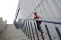 Rear view of runner athlete running on stairs. Woman fitness is jogging oudoors Royalty Free Stock Photo