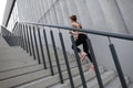 Rear view of runner athlete running on stairs. Woman fitness is jogging oudoors Royalty Free Stock Photo