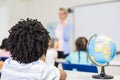 Rear view of school boy studying in classroom Royalty Free Stock Photo