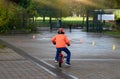 Rear view School kid learns to ride a bike in the Park, Outdoor Portrait of a young boy practicing how to ride a bicycle  , Child Royalty Free Stock Photo