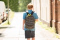 Schoolboy Walking On Sidewalk Royalty Free Stock Photo