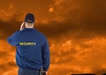 Rear view of security guard against cloudy sky during sunset Royalty Free Stock Photo