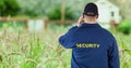 Rear view of security guard on field Royalty Free Stock Photo