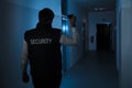 Security Guard Standing In Corridor Of The Building