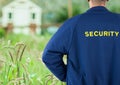 Rear view of security guard standing on field Royalty Free Stock Photo