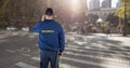 Rear view of security guard standing on road in city Royalty Free Stock Photo