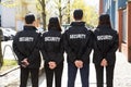 Rear View Of Security Guards Standing In A Row Royalty Free Stock Photo