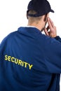Rear view of security officer listening to earpiece Royalty Free Stock Photo