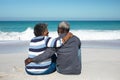 Old couple sitting on the sand Royalty Free Stock Photo