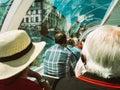 Rear view of senior couple passengers tourists. sightseeing through the large