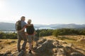 Rear View Of Senior Couple Standing At Top Of Hill On Hike Through Countryside In Lake District UK Royalty Free Stock Photo