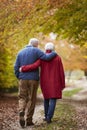 Rear View Of Senior Couple Walking Along Autumn Path Royalty Free Stock Photo