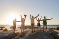 Rear View Of Senior Friends Standing On Rocks On Vacation With Arms Outstretched Royalty Free Stock Photo