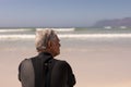 Rear view senior male surfer relaxing on the beach Royalty Free Stock Photo