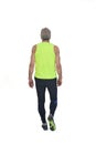 Rear view of a senior man with sportswear walking Royalty Free Stock Photo