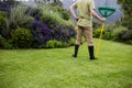 Rear view of senior man standing with garden tool Royalty Free Stock Photo