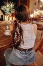 Rear view of a sexy young woman with a ponytail and a headband sitting on her back on a terrace drinking a cup of coffee in the