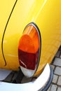 Rear view of a yellow classic car with rear light and bumper Royalty Free Stock Photo