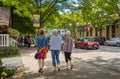 Rear view shot of three women walking together on city street. Female friends out on the street on a summer day Royalty Free Stock Photo