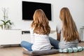 Rear view of siblings watching TV at home Royalty Free Stock Photo
