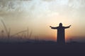 Rear view silhouette of Jesus Christ raised hands and praying to god Royalty Free Stock Photo
