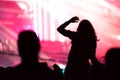 Rear view of a silhouette of a woman at concert Royalty Free Stock Photo