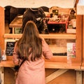 Rear view of single woman buying delicious Christmas Market alsatian food