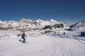 Rear view of skier skiing on snowy landscape under sky