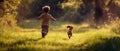 Rear view of a small kid running alongside a cute dachshund dog in a big grassy clearing. Daytime outside in the woods