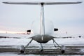 Rear view of the small sports airplane at the winter airfield in sunset Royalty Free Stock Photo