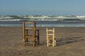 Rear view small wicker chairs stand up in the seashore Royalty Free Stock Photo